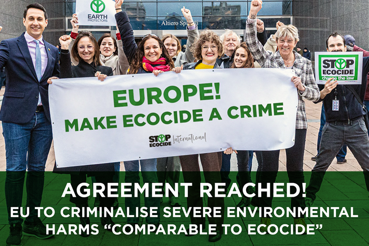 Stop Ecocide campaigners standing outside an EU building holding a banner about Ecocide.