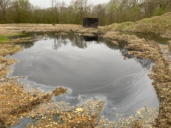 Photo of landfill site with puddles